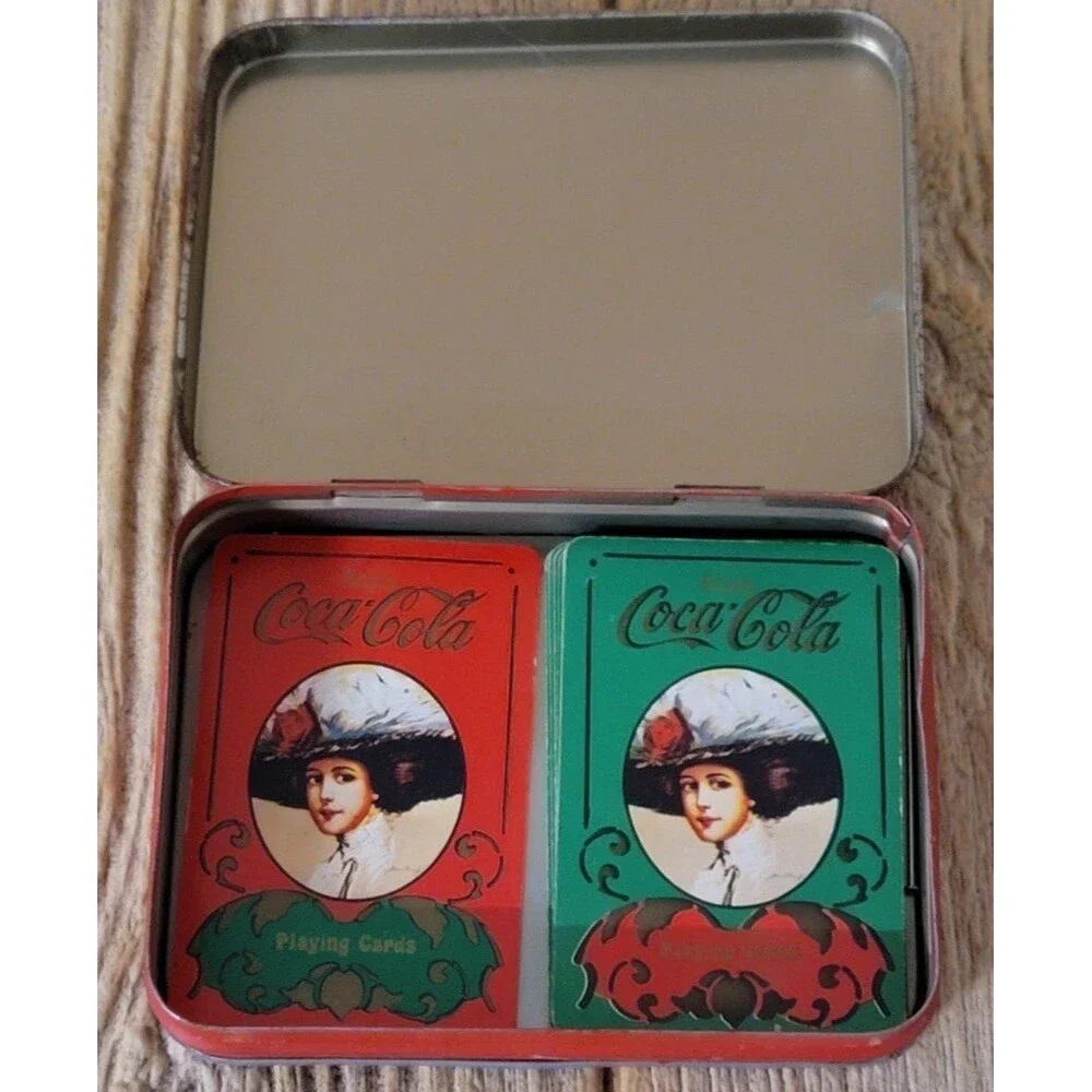 Coca-Cola card holding tin.